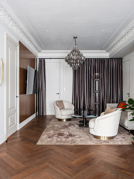 Luxurious living room with ornate ceiling, chandelier, and plush furnishings.