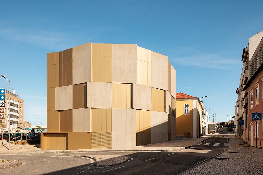 A modern, angular building with a distinctive geometric facade in warm, earthy tones.