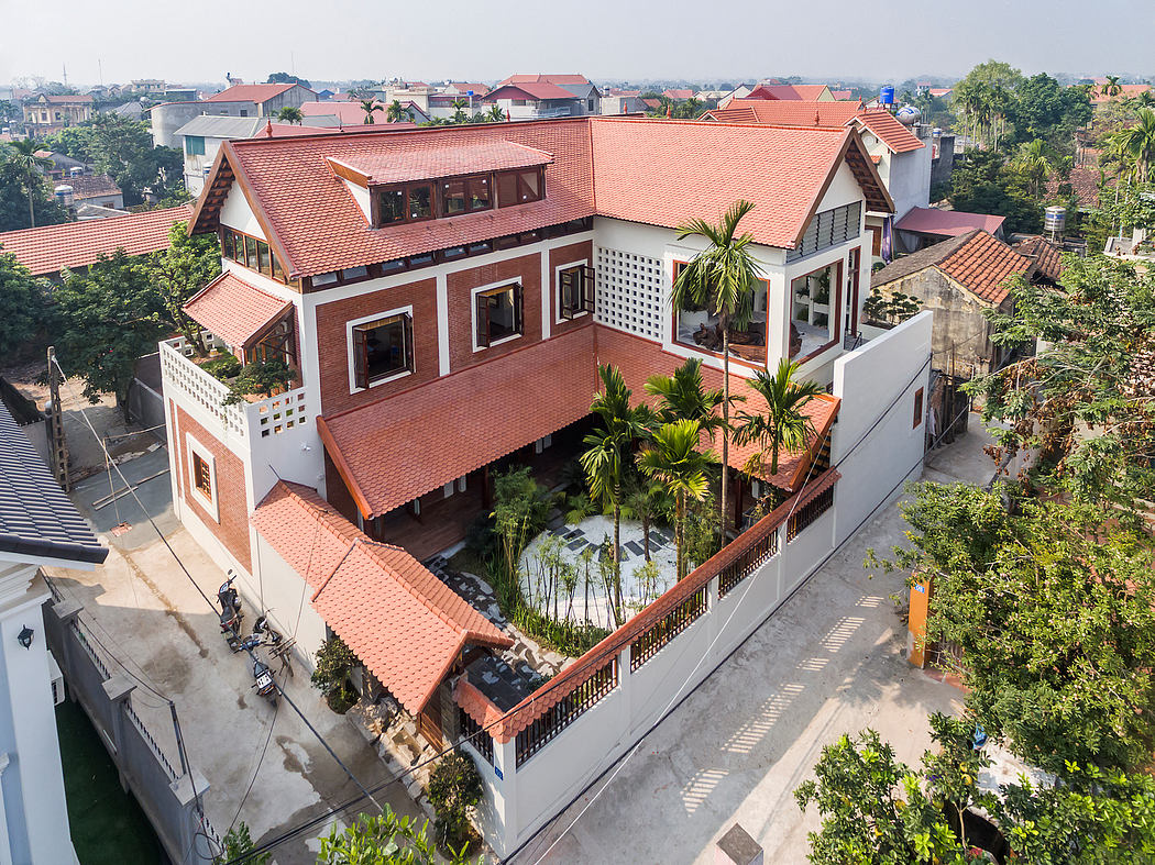 Ornate brick-and-tile villa with tropical garden courtyard and panoramic city views.