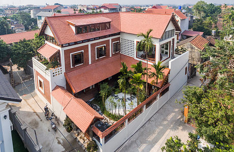 Ornate brick-and-tile villa with tropical garden courtyard and panoramic city views.