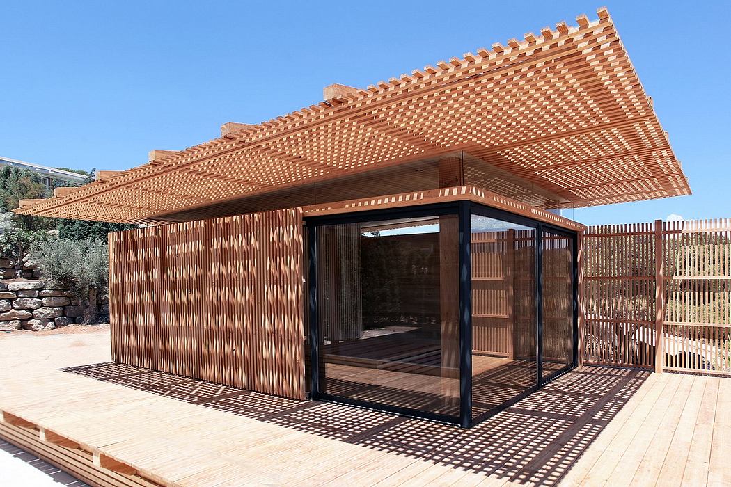 A modern wooden structure with a striking patterned roof and open interior spaces.