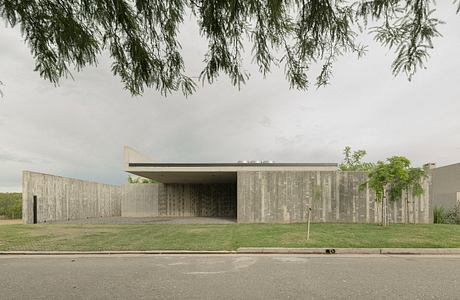 Striking modernist concrete building with clean architectural lines and natural surroundings.