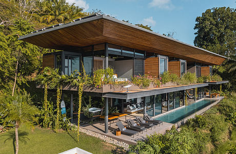 Stunning modern tropical villa with sweeping roof, vast terrace, and infinity pool.