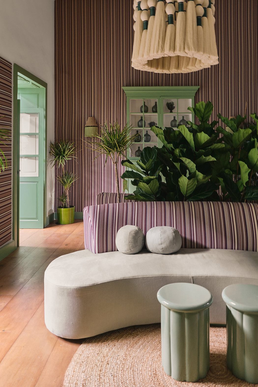 A vibrant, nature-inspired interior design with plush seating, greenery, and bold color accents.