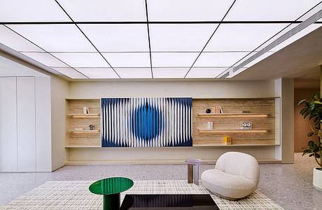 Sleek, modern office space with wood paneling, geometric artwork, and minimalist furnishings.