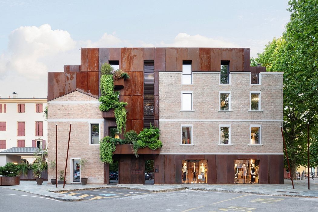 Modern mixed-use building with brick and rusted steel facade, green accents, and retail spaces.