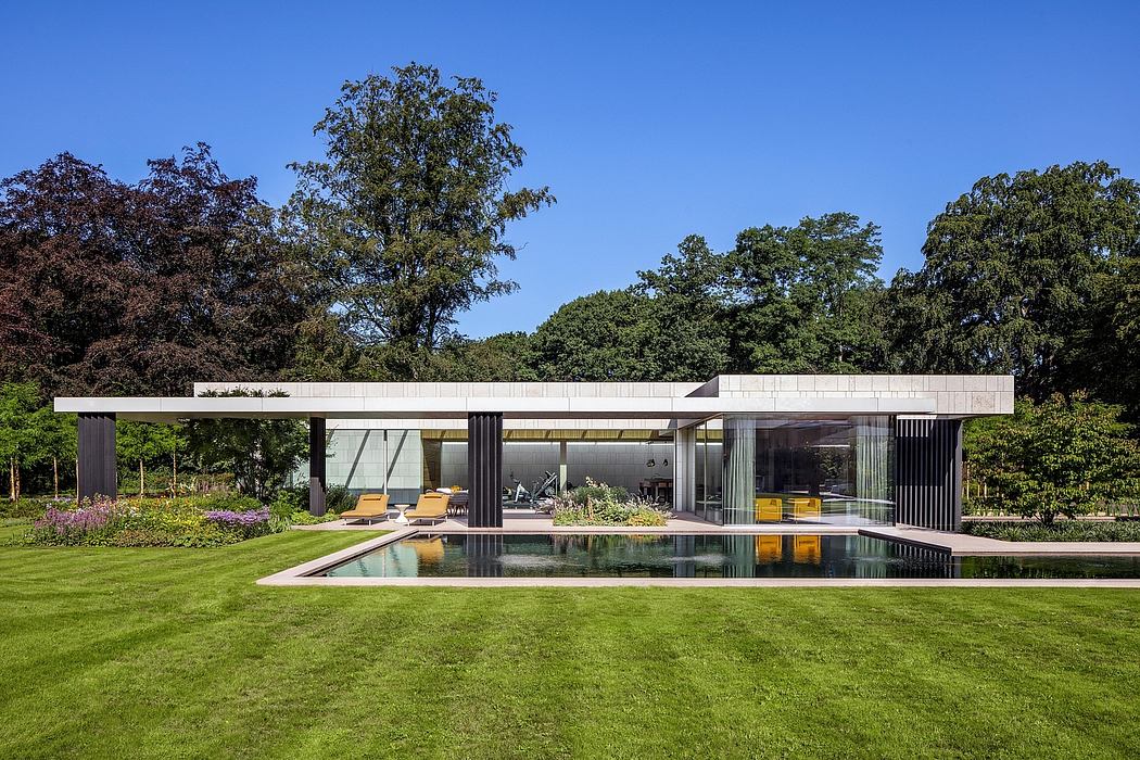 A modern, minimalist house with a sleek pool and lush, green landscaping.