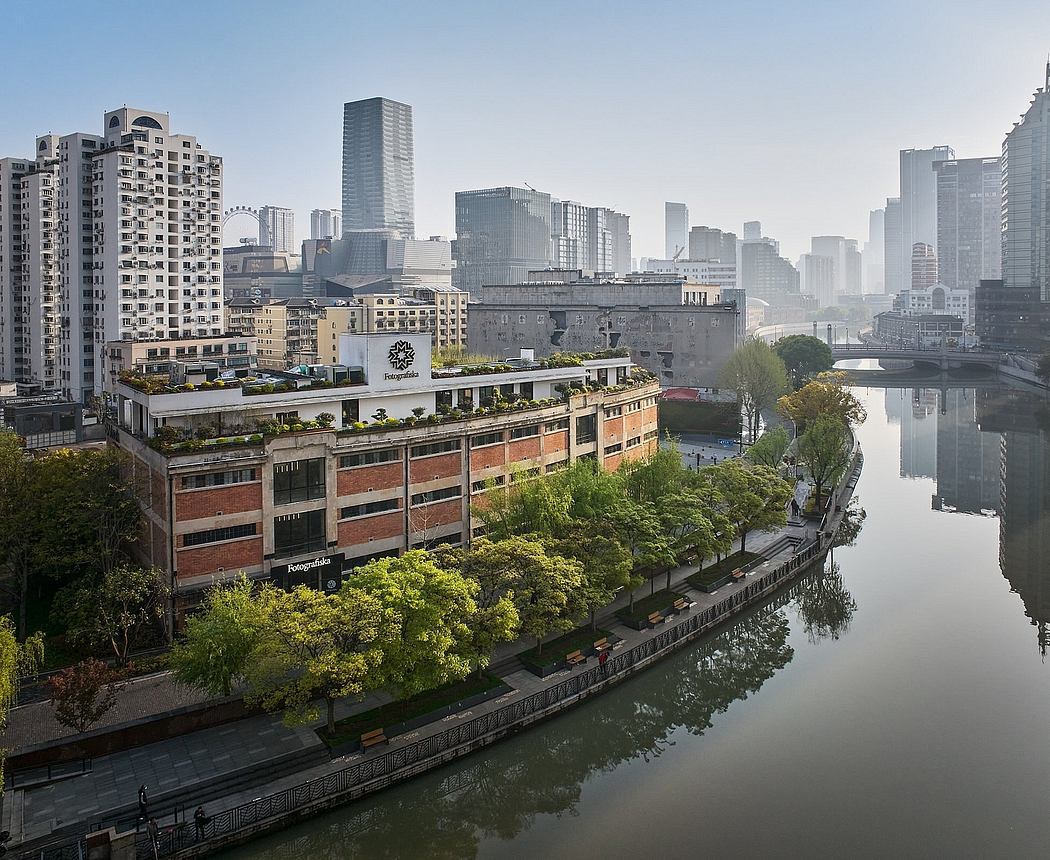 Vibrant cityscape with high-rise buildings, greenery, and a tranquil waterway.
