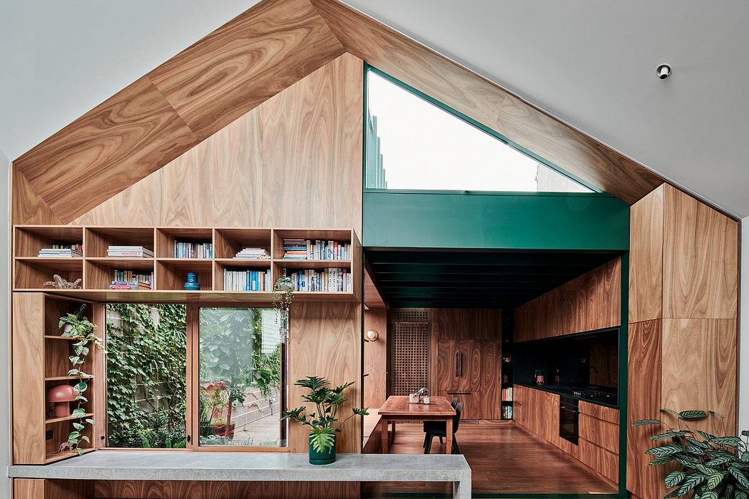 Striking wood-paneled interior with built-in shelving, large windows, and plants.