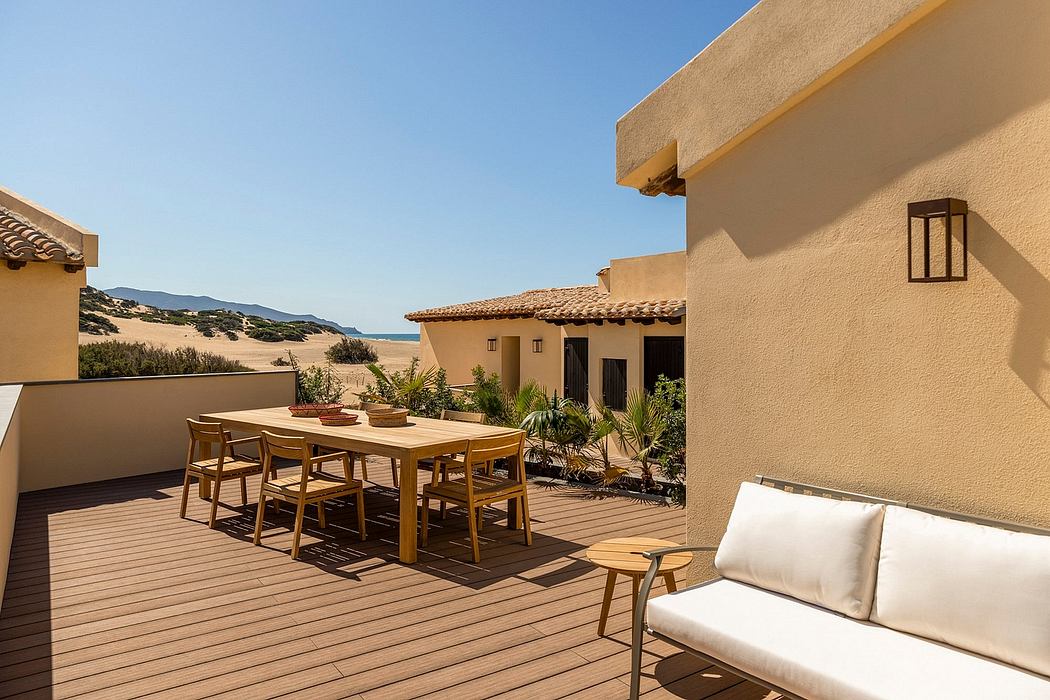 Warm-toned stucco exterior with tiled roof, wooden deck, and minimalist furnishings.