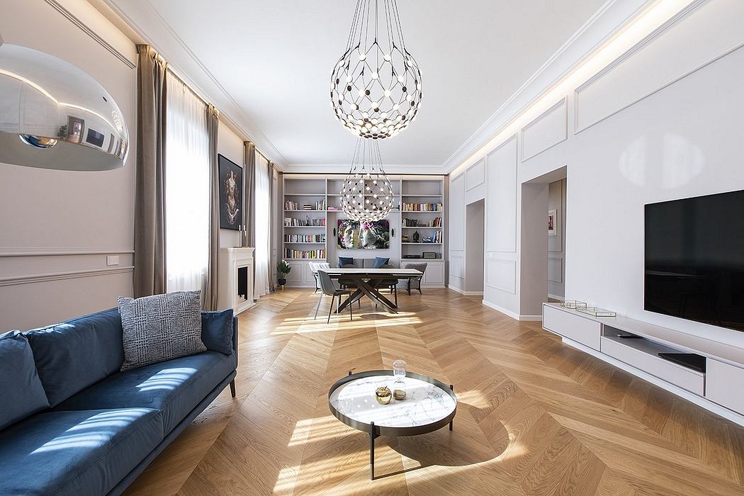 Elegant living room with herringbone wood flooring, chandelier, and built-in shelving.