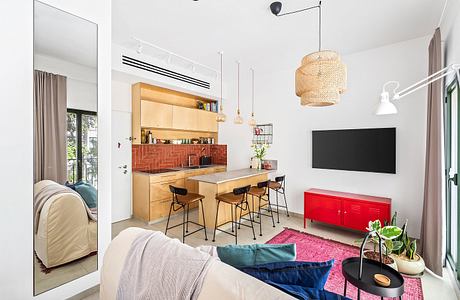 Bright, modern kitchen with wooden cabinetry, red tiled backsplash, and an open floor plan.