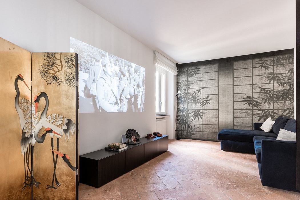 Minimalist living room with Japanese-inspired artwork and sliding panels, sleek furnishings.