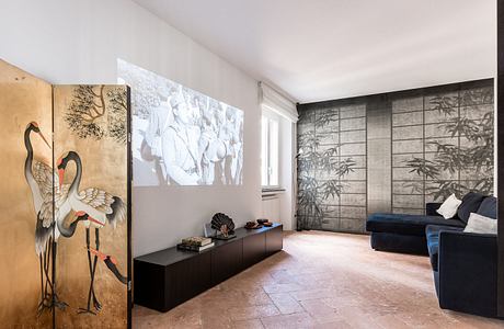 Minimalist living room with Japanese-inspired artwork and sliding panels, sleek furnishings.