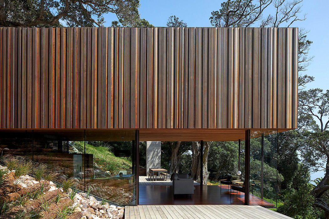 Wooden slatted facade with expansive glass walls and elevated outdoor terrace.