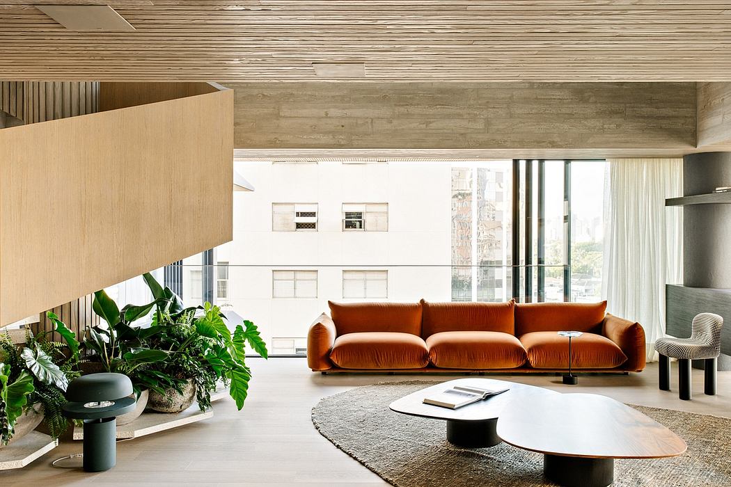Warm, modern living space with rustic wood panels, plush orange sofa, and circular coffee tables.