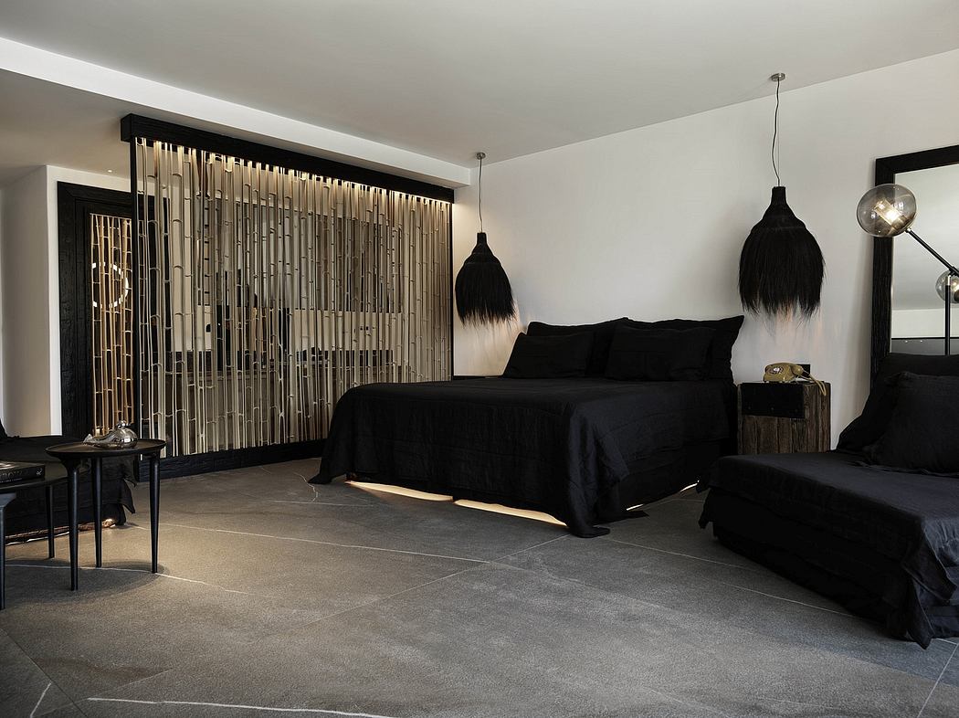Sleek, modern bedroom design with a black and gray color scheme, featuring a large bed and unique lighting fixtures.