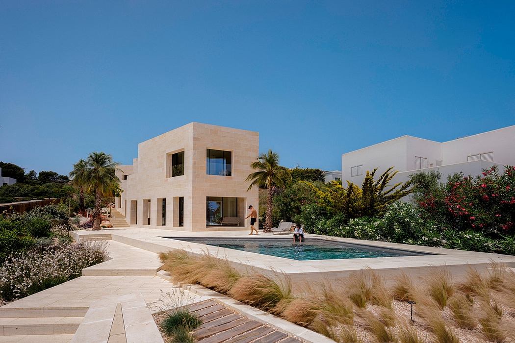 Modern Mediterranean-style villa with sleek exterior, lush landscaping, and inviting pool.