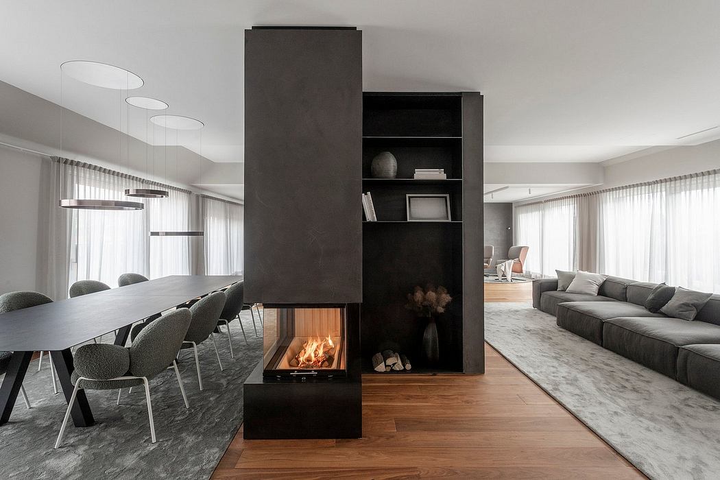Modern, minimalist living space with sleek black fireplace unit, open floor plan, and natural materials.