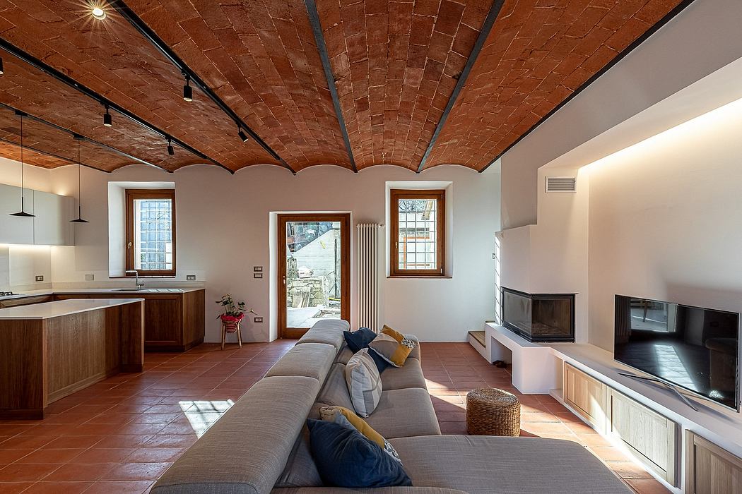Brick vaulted ceiling, wood furnishings, and modern amenities in cozy living space.