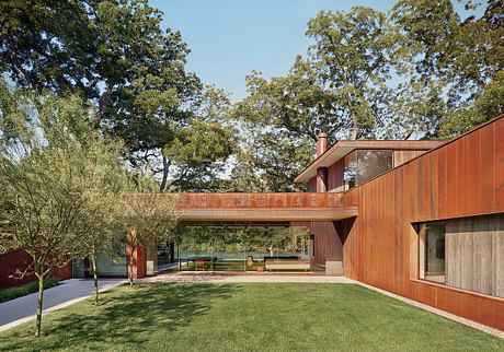 A modern, single-story home with a wooden exterior, large windows, and a covered patio.