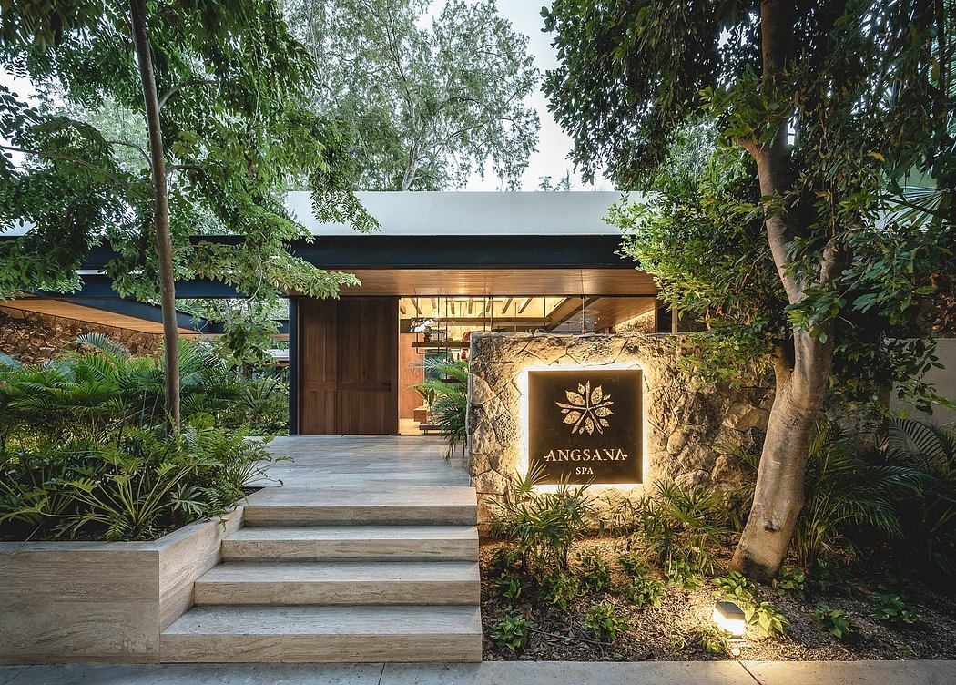 Lush tropical setting frames the earthy, modern architecture of the Angsana Spa entrance.