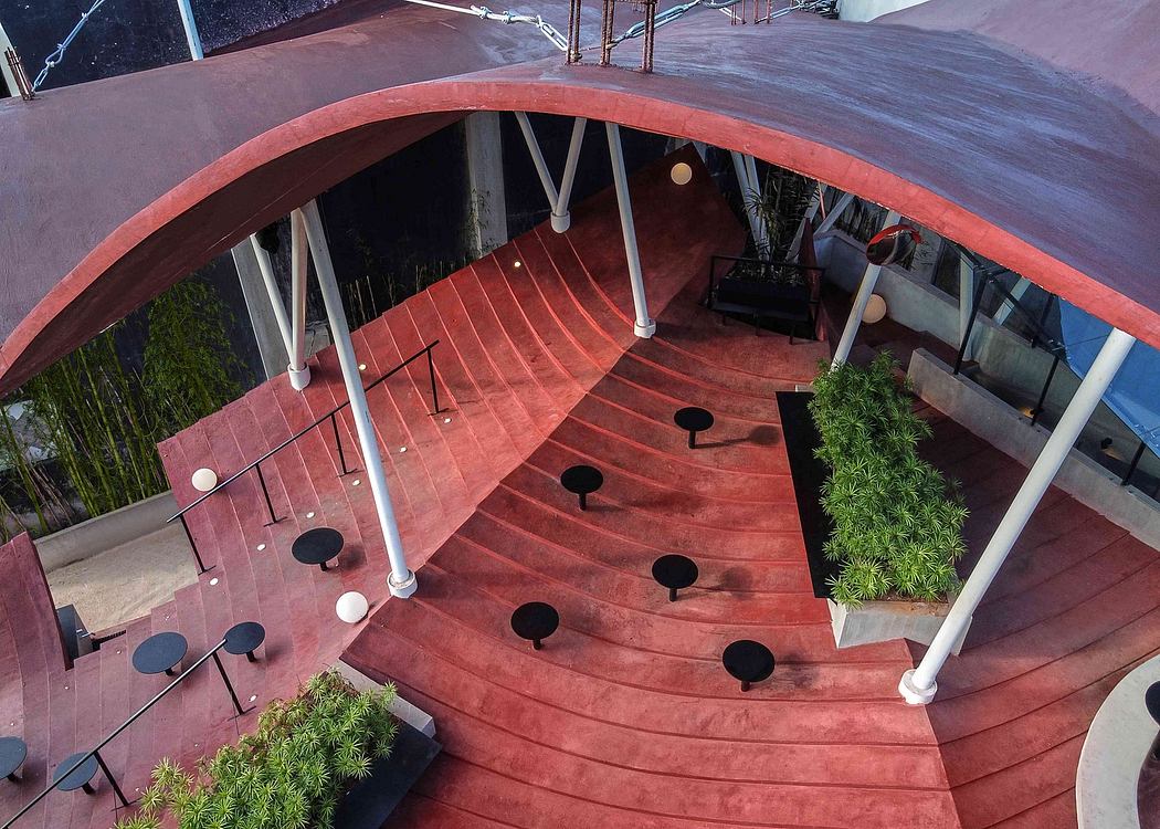 Striking architectural design with curved wooden stairs, overhead structure, and potted plants.