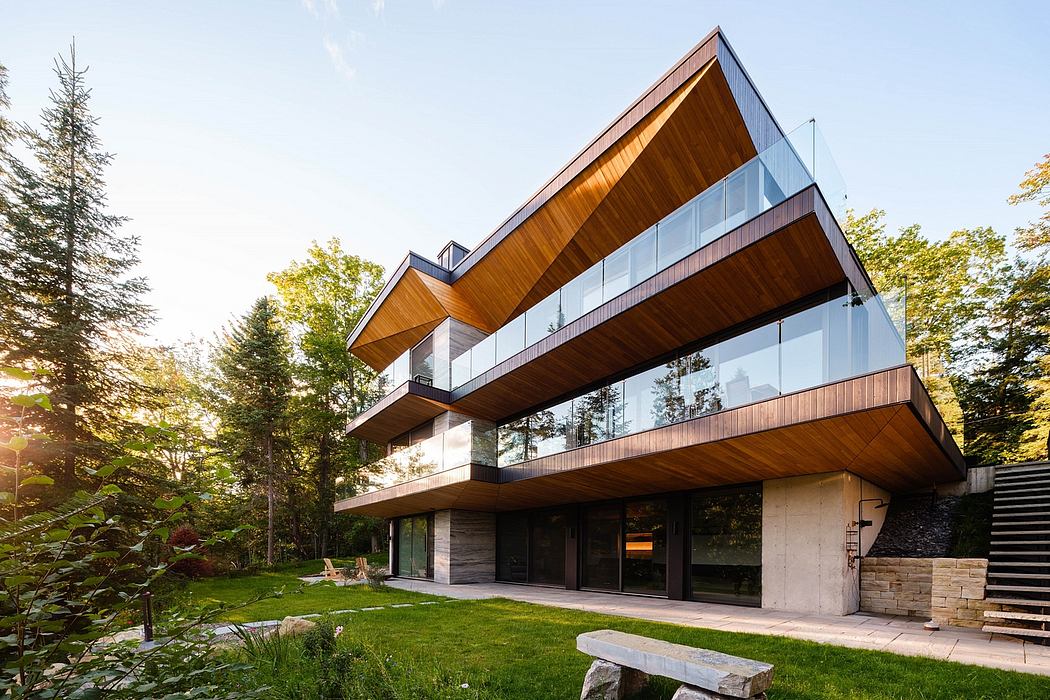 Striking modern design with wood, glass, and concrete elements, surrounded by lush greenery.