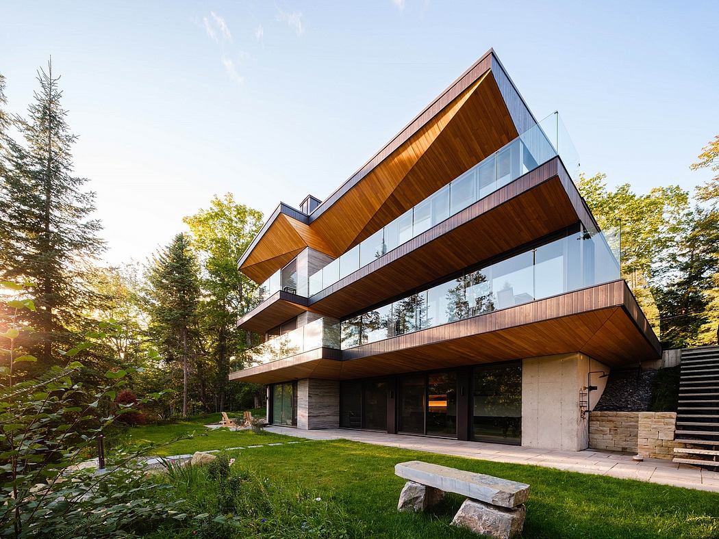 Striking modern design with wood, glass, and concrete elements, surrounded by lush greenery.