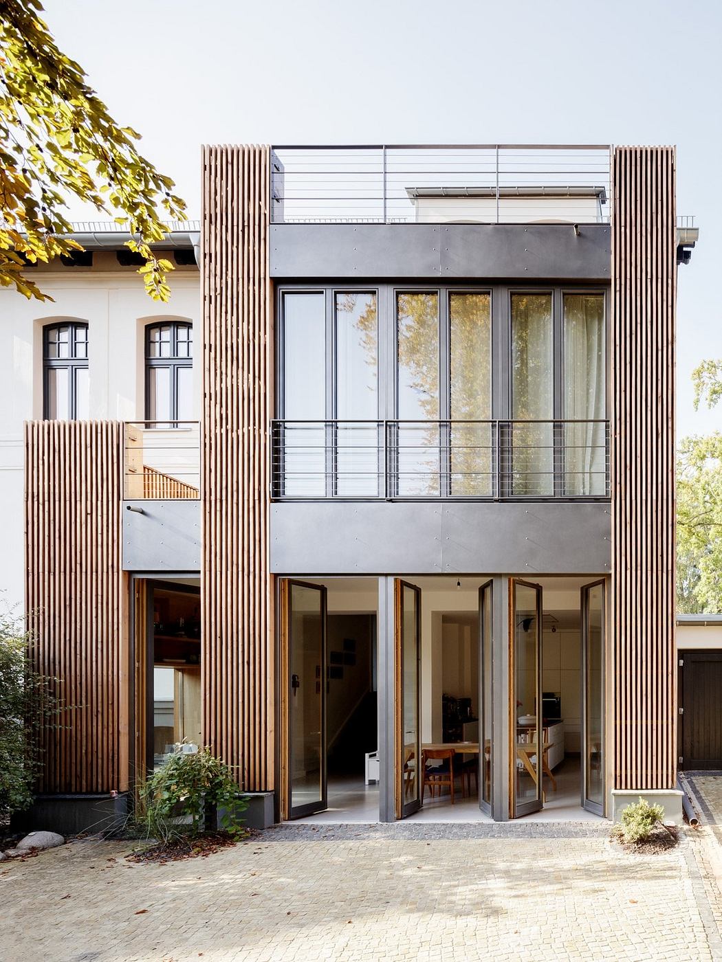 Modern architecture with wooden facade, large windows, and minimalist design.
