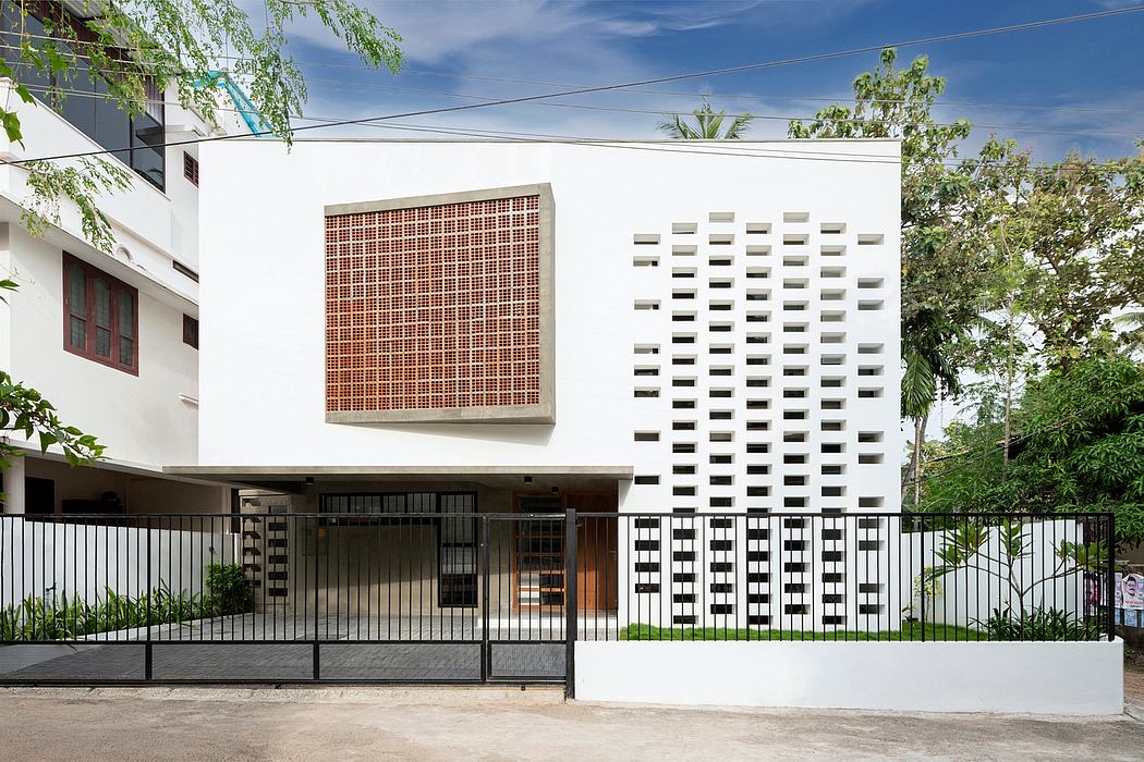 Modern building featuring intricate lattice work and minimalist facade with geometric patterns.