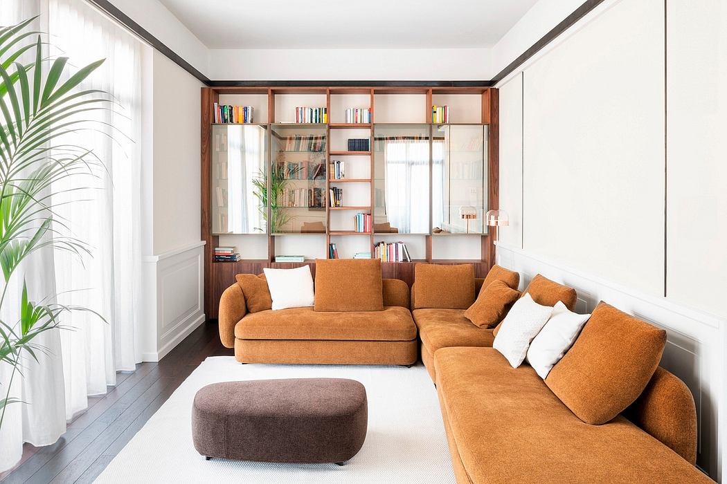 Warm, cozy living room with wood shelving, plush orange sofa, and potted plant.