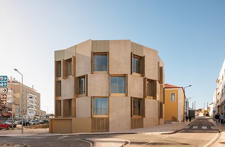 A modern multi-story building with distinctive cuboid window arrangements and textured facade.