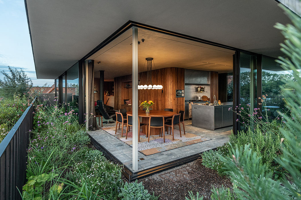 A modern, open-concept home with wooden accents, floor-to-ceiling windows, and a lush outdoor garden.
