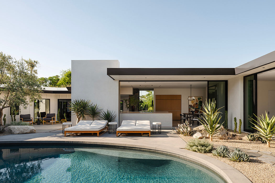 Modern desert landscaping with pool, minimalist architecture, and outdoor living space.