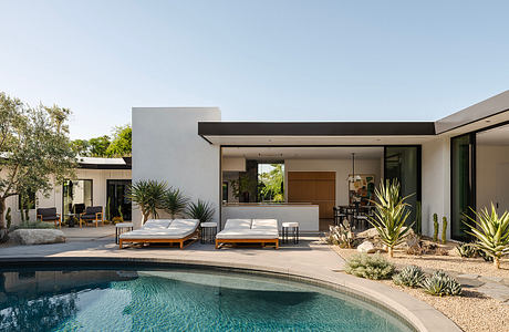 Modern desert landscaping with pool, minimalist architecture, and outdoor living space.