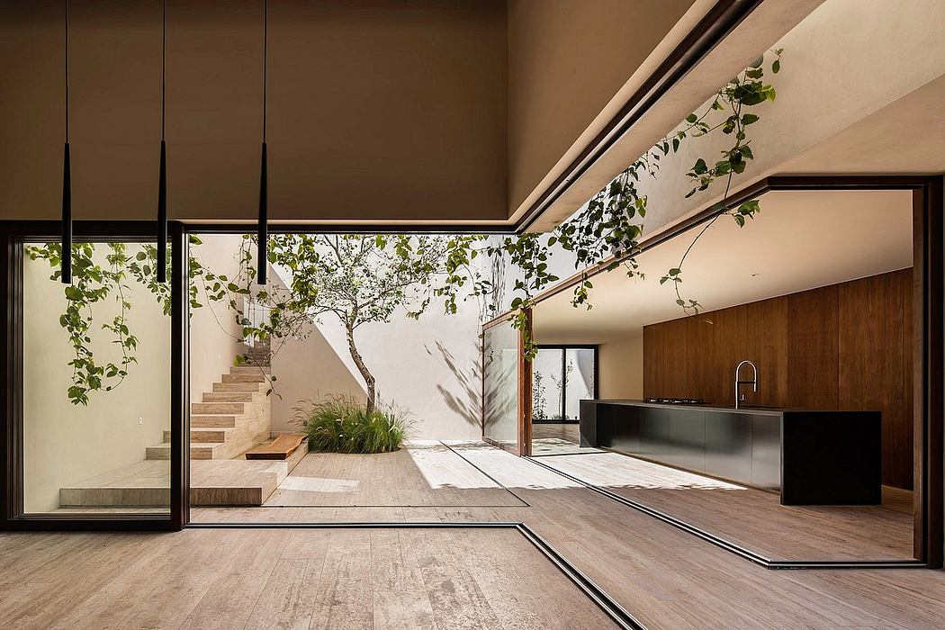 Spacious interior with natural lighting, wood accents, and a verdant courtyard view.
