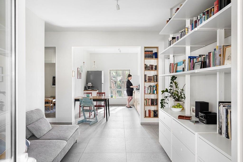 Cozy living space with sleek built-in bookshelves, minimalist furniture, and natural light.