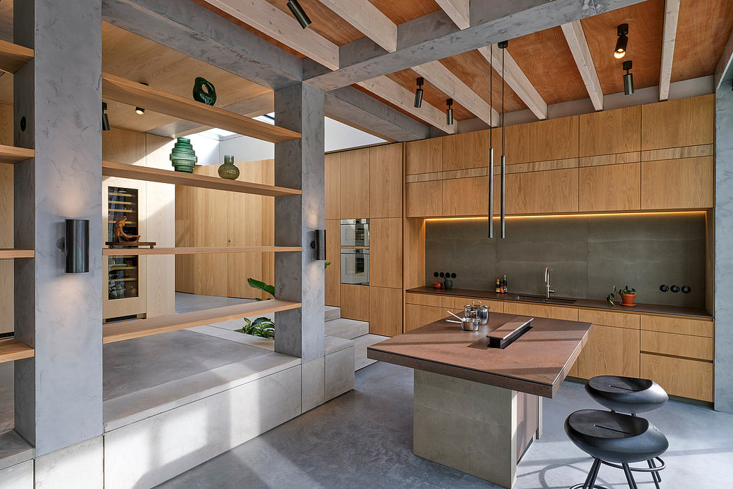 Sleek, modern kitchen with concrete and wood accents, open shelving, and island seating.