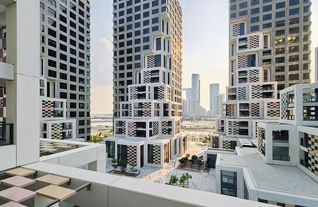 Modern high-rise buildings with bold geometric patterns and varied textures, creating an architecturally striking urban landscape.