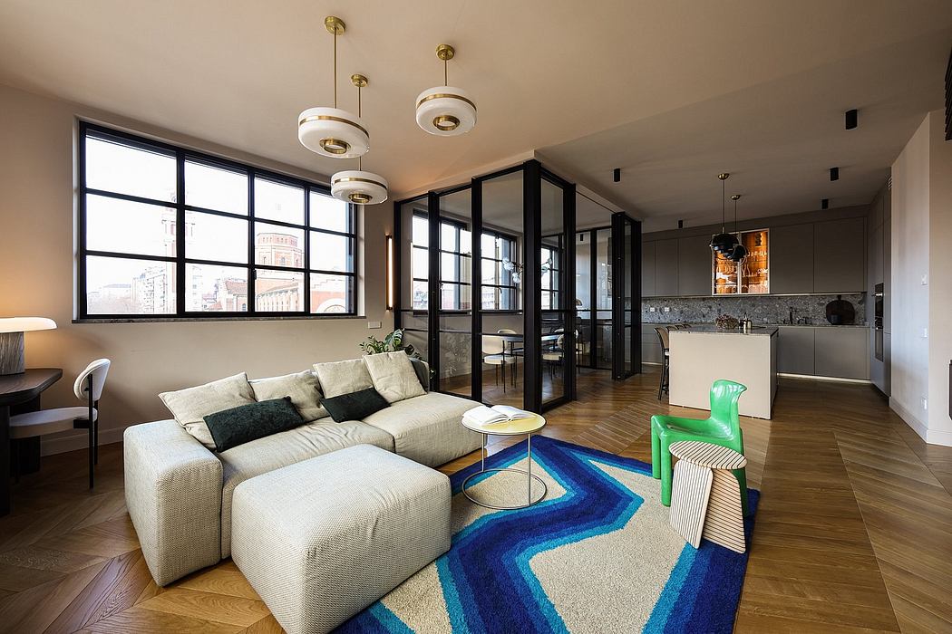 Modern open-concept living space with large windows, geometric rug, and pendant lighting.