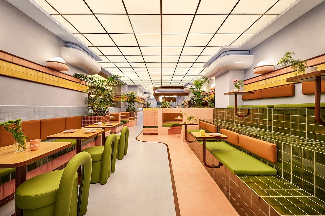 The image depicts a vibrant, modern restaurant interior with a grid-like ceiling, green and orange seating, and tropical plants.