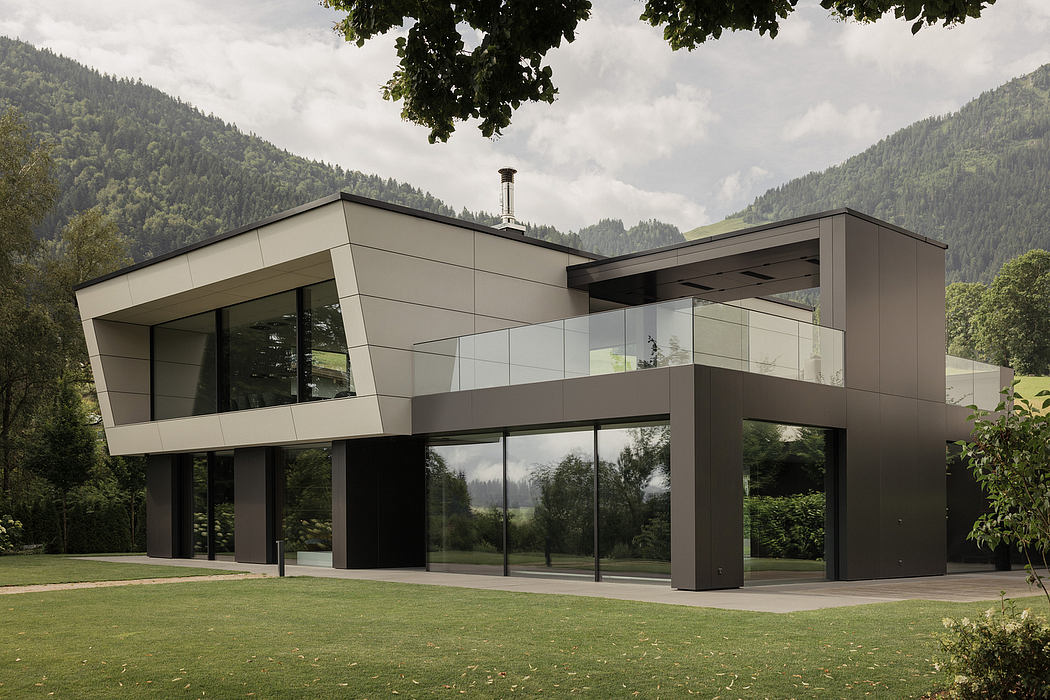 Modern architectural design with sleek glass walls, overhanging roof, and lush surrounding landscape.