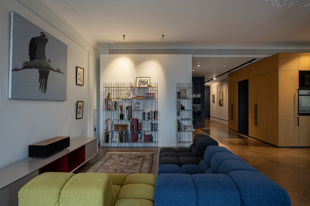 Stylish modern living room with sleek furniture, artful shelving, and warm lighting.