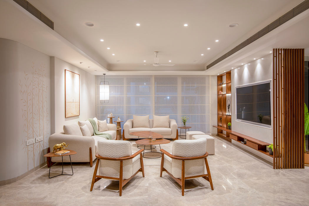 Spacious living room with sleek modern furniture, warm lighting, and minimalist decor.