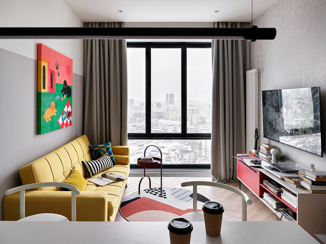 Stylish living room with modern furniture, vibrant artwork, and panoramic city view.