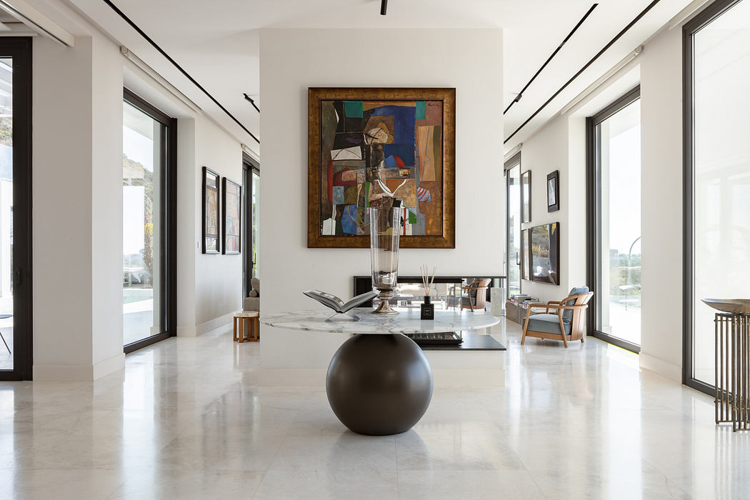 Elegant modern interior with minimalist decor, abstract artwork, and sleek marble flooring.