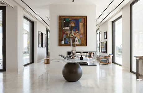 Elegant modern interior with minimalist decor, abstract artwork, and sleek marble flooring.