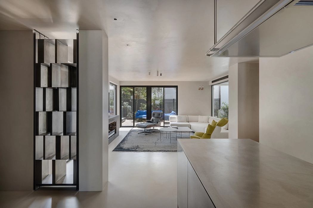Sleek, modern interior with minimalist furniture, concrete floors, and large windows.