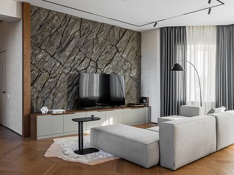 Sleek, contemporary living room with a striking stone accent wall, minimalist furniture, and hardwood flooring.